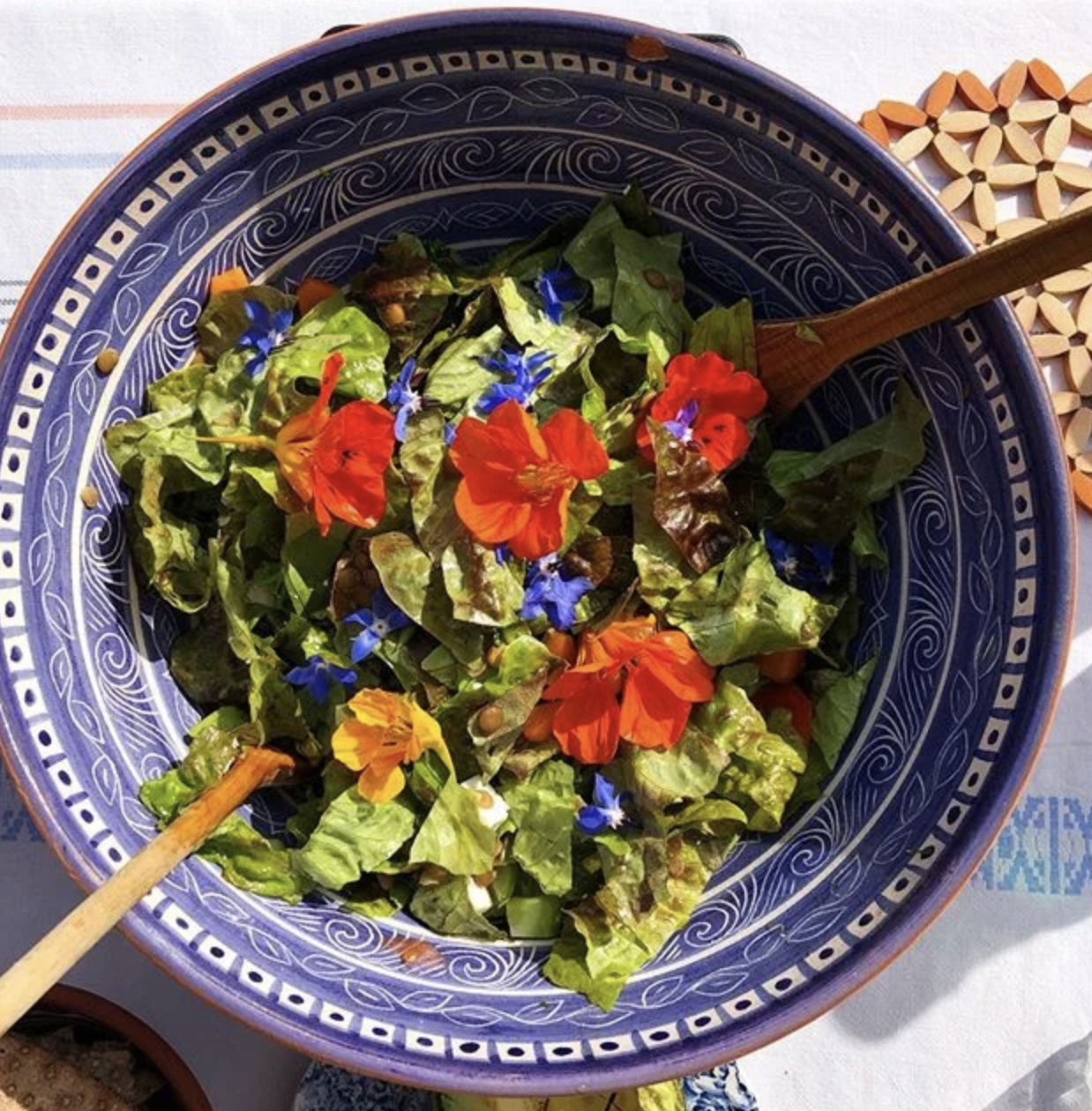 A bowl of colourful nourishing Ayurvedic food in a blue bowl. 